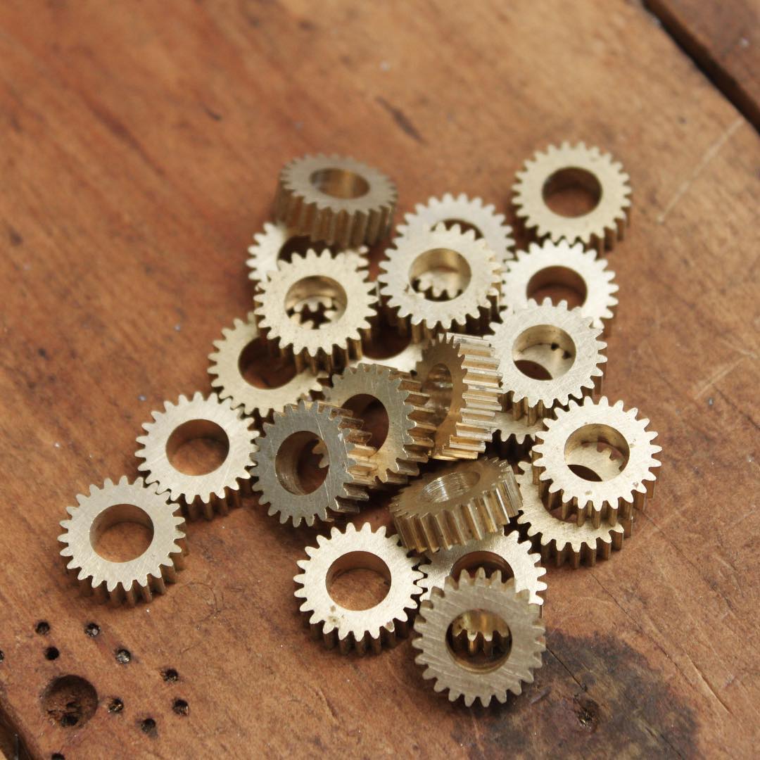 Involute spur gears cut as one long gear on a 4-axis CNC mill as one long gear, then sliced to the final width